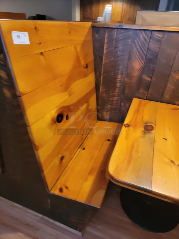Rustic wooden booth and table set with natural finish, cozy seating, perfect for restaurants or cafes. Visible label: "Sale 90E."