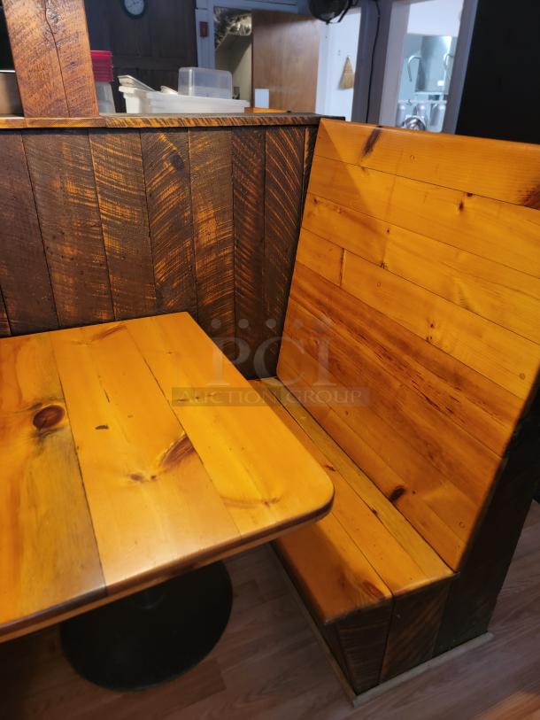 Rustic wooden restaurant booth and table set. Features natural wood finish with visible grain. Ideal for cozy dining spaces.