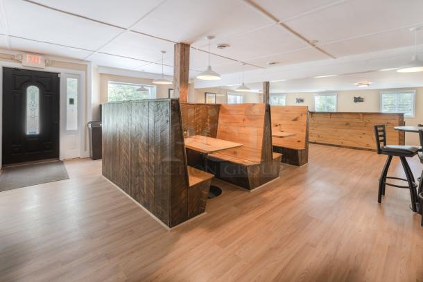 Rustic wooden restaurant booths and tables, various sizes, showcasing cozy, warm-toned wood in good condition.
