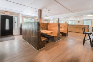 Rustic wooden restaurant booths and tables, various sizes, showcasing cozy, warm-toned wood in good condition.