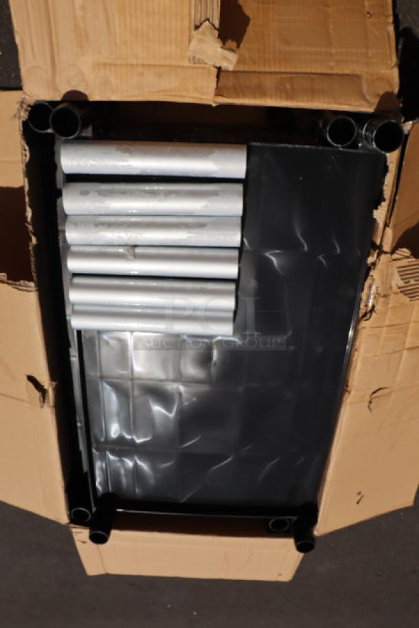 Brand new Choice black utility bussing cart with three shelves, scratch & dent condition, packaged with assembly parts visible.