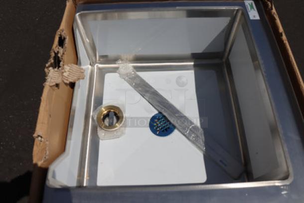 BRAND NEW Regency 16-gauge stainless steel mop sink with notched front bowl. Visible packaging wear. Includes drain kit.