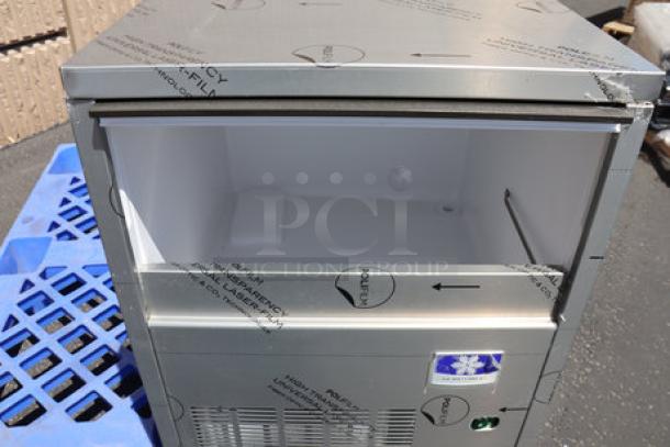 Manitowoc undercounter air-cooled nugget ice machine, stainless steel exterior, open top, protective film, excellent condition.