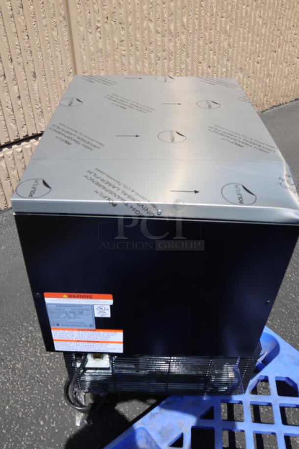 Manitowoc Undercounter Air Cooled Nugget Ice Machine, new condition, protective covering on top, visible labels with instructions.