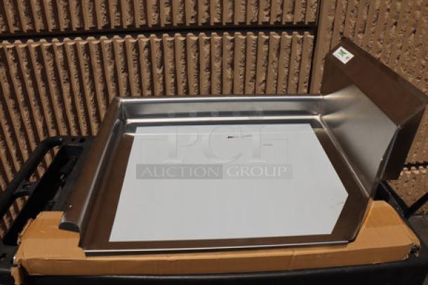 Brand new Regency 16-gauge 2' clean dish table with left drainboard; visible scratch, on a cardboard box.