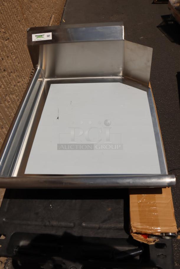 BRAND NEW Regency 16 Gauge 2' Clean Dish Table with Left Drainboard, minor scratches, stainless steel, protective covering.
