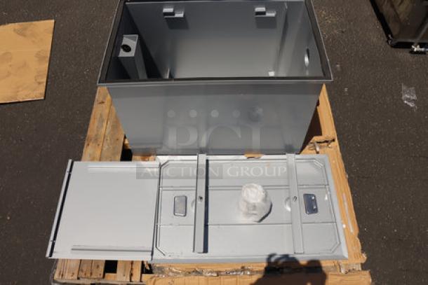 Brand new Regency 600GT35 grease trap, 35 GPM, non-threaded 3" connections, slight scratches, sitting on a wooden pallet.