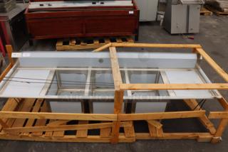 Regency 600S3182424 stainless steel three-compartment commercial sink with two drainboards. Minor scratches and dents.