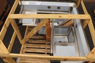 Brand new Regency 600S3141414XC stainless steel corner sink with three 14"x14"x14" bowls, two drainboards, and basket drains.