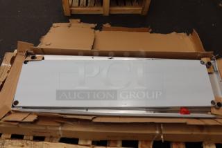 BRAND NEW Regency 600TSB2472S stainless steel work table, 24"x72", with 4" backsplash. Packaging damaged.