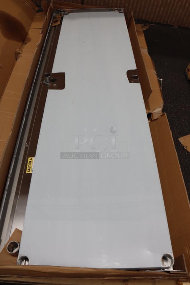 Regency 600TSB3096S 30" x 96" stainless steel work table, 4" backsplash, undershelf, damaged packaging, scratches, and dents.
