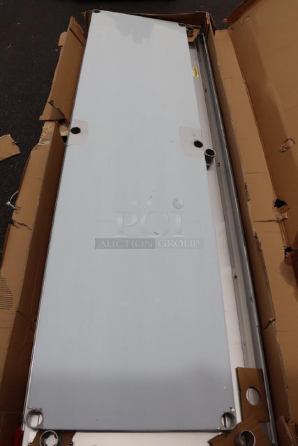 Regency 600TSB3096S stainless steel work table, 30"x96", 16-gauge, with backsplash and undershelf. Packaging damaged, scratches and dents visible.
