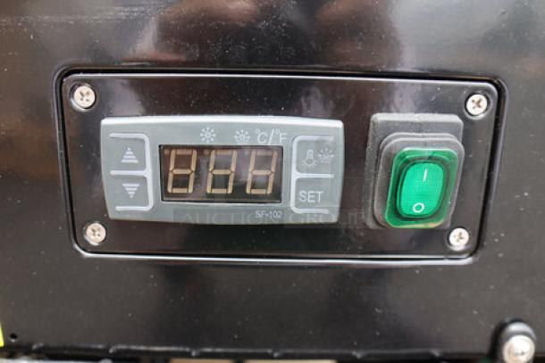 Close-up of Avantco BC-60-HCB control panel with temperature display and green power switch, on a new refrigerated bakery display case.