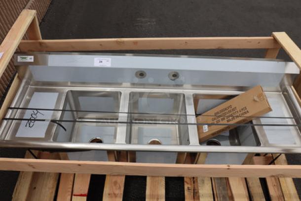 Regency 600S31416212 stainless steel three-compartment sink with galvanized legs and two drainboards, minor scratches/dents.