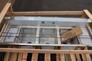 Regency 600S31416212 stainless steel three-compartment sink with galvanized legs and two drainboards, minor scratches/dents.
