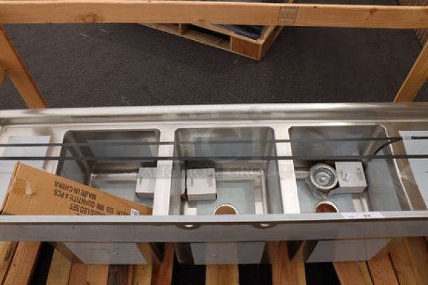 Regency 600S31416212 stainless steel three-compartment sink with galvanized legs, two drainboards. Minor dents/scratches possible.