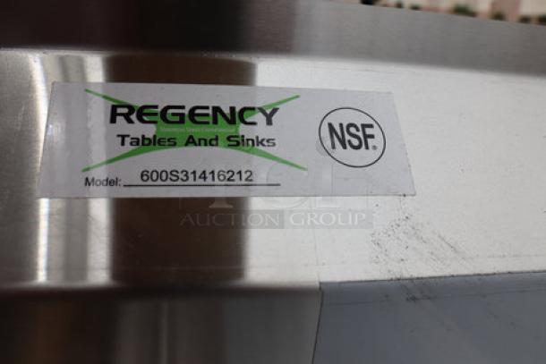 Regency 600S31416212 stainless steel sink label, showing model and NSF certification. Slight scratches visible.
