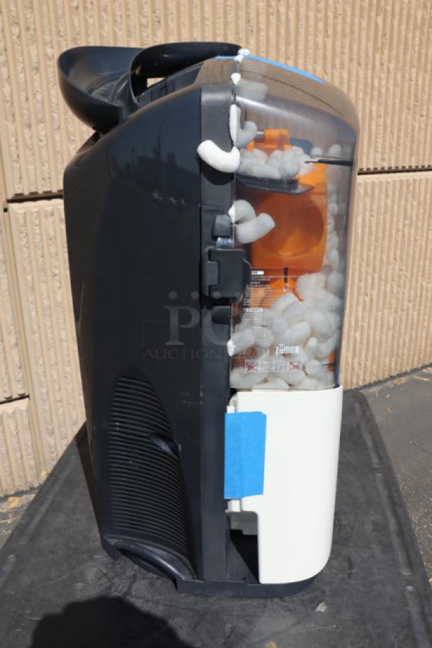 BRAND NEW Zumex 04917 dark black Minex orange juicer. Minor front panel damage. Juices 13 oranges/minute. Multitension 100-240V.