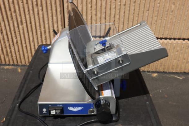 BRAND NEW Vollrath 40951 12" Meat Slicer, medium duty, 2/5 hp, 120V. Sharpener support damaged, model and serial numbers visible.
