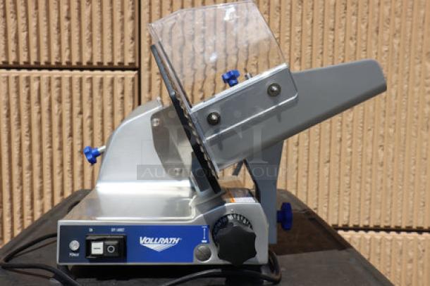 Brand new Vollrath 40951 12" meat slicer, medium duty, 2/5 hp, 120V, S/N: 0275-00569587-023. Sharpener support damaged.