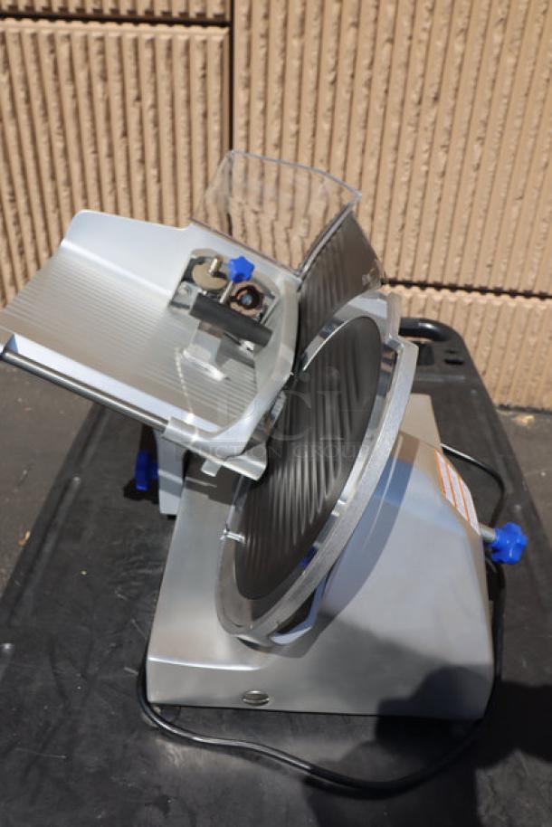 Brand new Vollrath 40951 12" meat slicer, 2/5 hp, 120V, 1.8A, 1 Phase; sharpener support damaged. S/N: 0275-00569587-023.