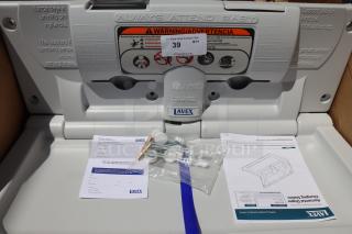 Lavex 475BCS100GY gray wall-mounted baby changing station, brand new, out of packaging, with installation instructions.