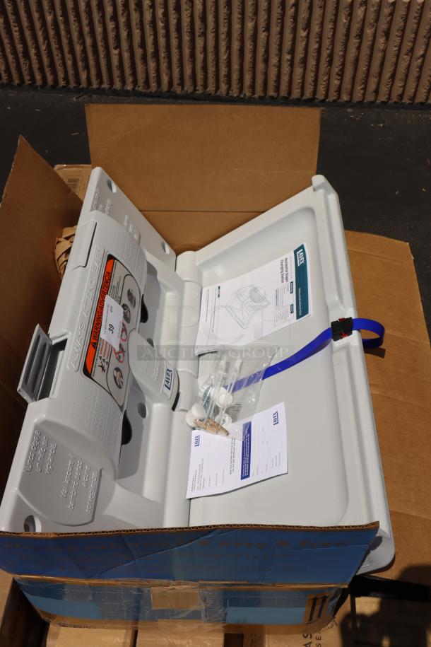 Brand new Lavex 475BCS100GY gray wall-mounted baby changing station, out of packaging, with installation manual.