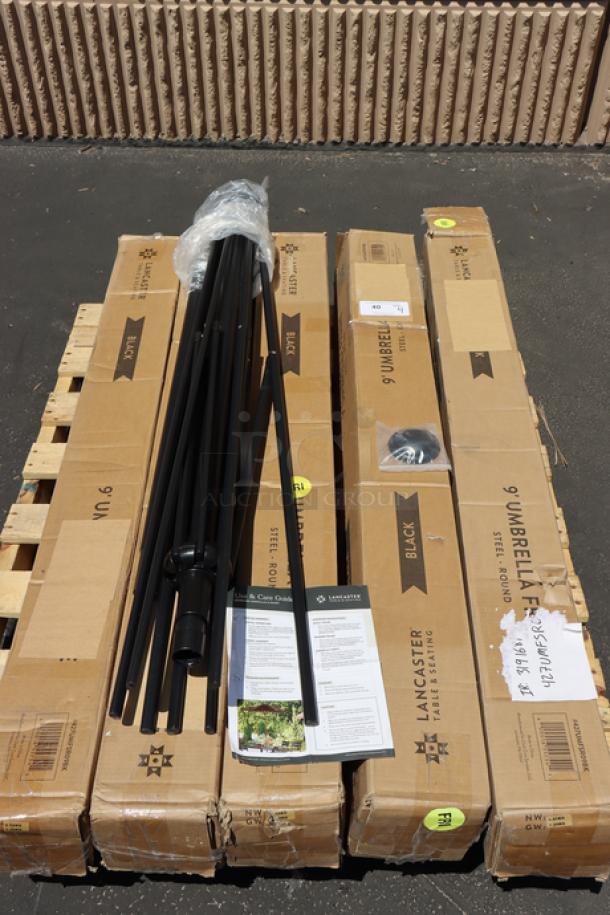 Brand new Lancaster Table & Seating 9' coal black umbrella, model 427UMFSR09BK. Includes black steel frame, boxes, and manual.