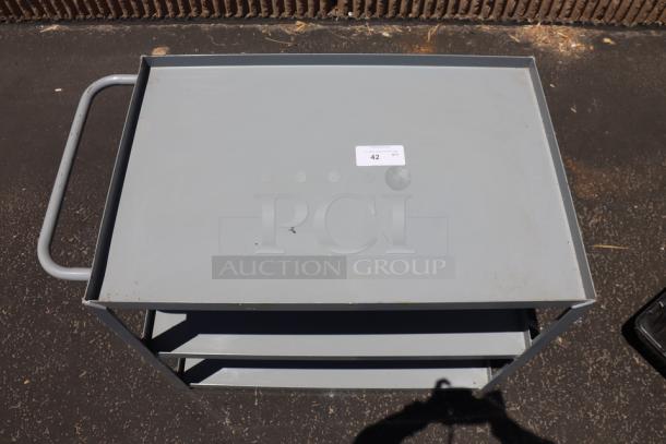 Brand new Lavex 36" x 24" x 35" steel utility cart, model 257LSUC24363. Three tray shelves, fully welded, missing wheels, tag #42.
