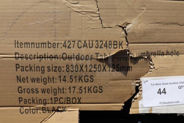 Damaged packaging for Lancaster Table & Seating outdoor table, model 427CAU3232BK, 32"x32", with an umbrella hole.