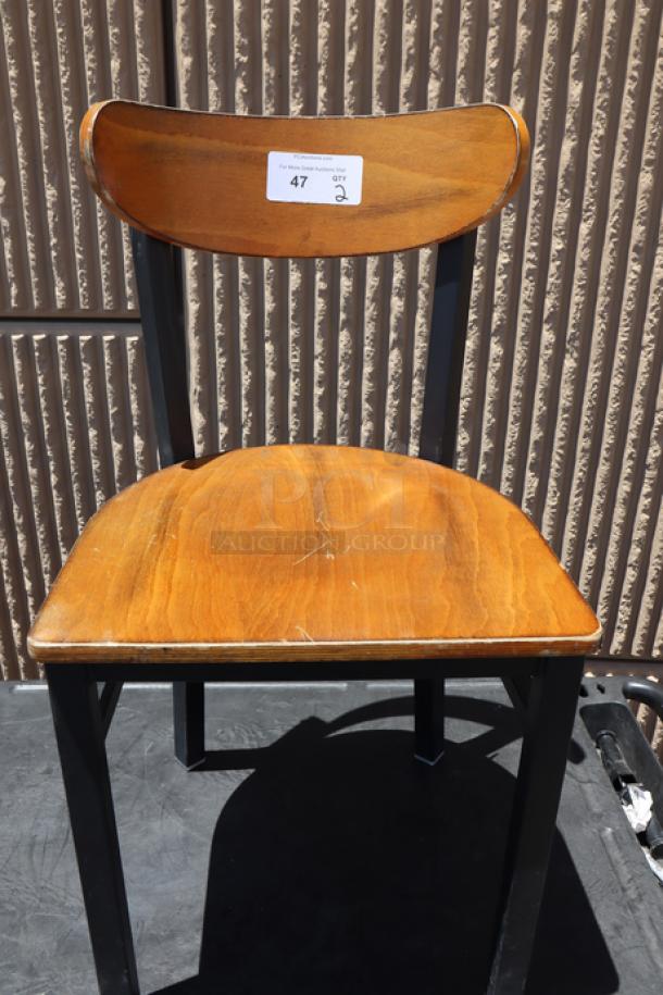 Lancaster Table & Seating chair, black finish with antique walnut wood seat and back, minor scratches visible, tag with "47" label.