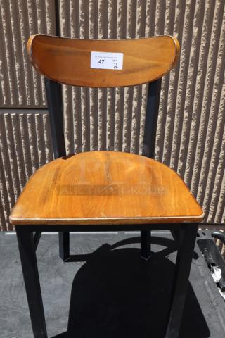 Lancaster Table & Seating chair, black finish with antique walnut wood seat and back, minor scratches visible, tag with "47" label.