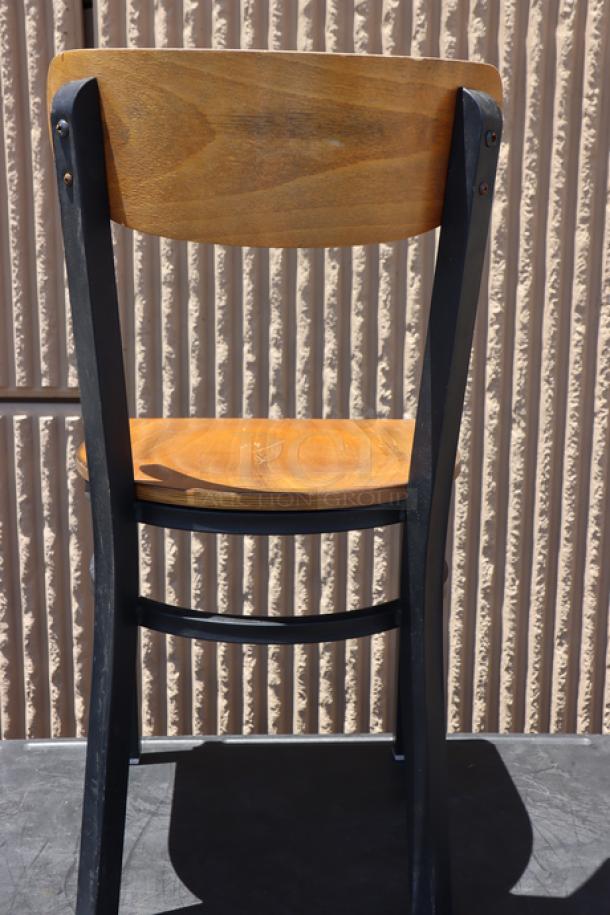 Brand new Lancaster Boomerang chair, black frame, antique walnut wood seat and back. May have minor scratching.