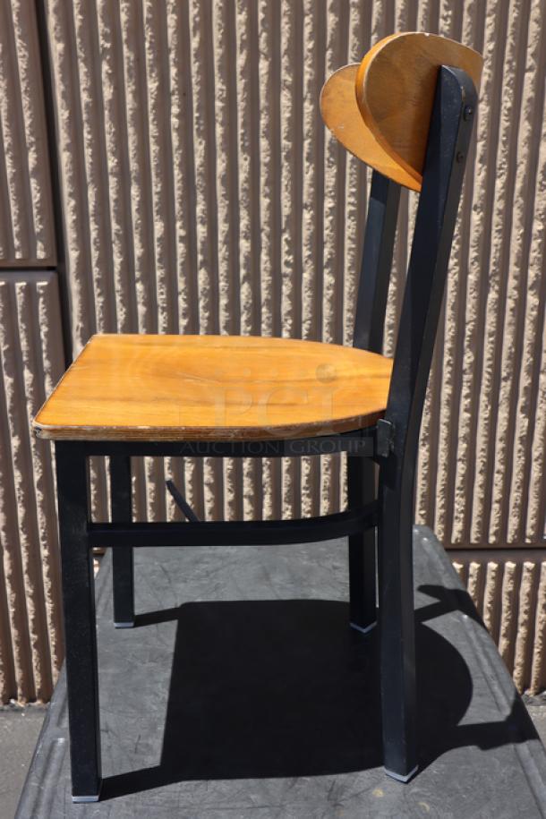 Brand new Lancaster Table & Seating chair, black finish with antique walnut wood seat and back. Possible minor scratches.