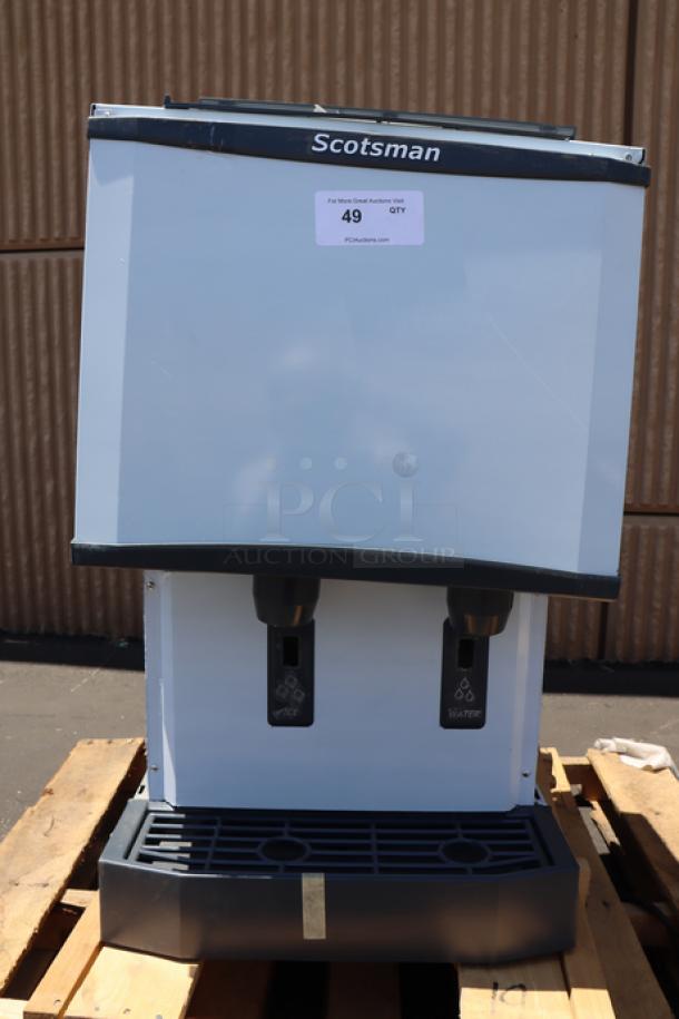 Brand new Scotsman HID525A-1 ice machine with 25 lb. bin, air cooled. Some dents on metal panels, unit intact. Model visible.