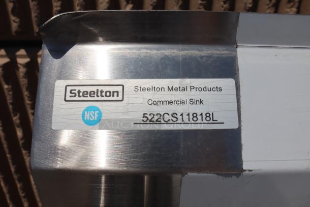 Steelton 522CS11818LT stainless steel commercial sink with minor dents and scratches. NSF label visible.