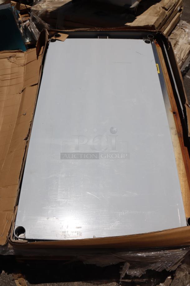 Regency 600TSB3660S 36" x 60" stainless steel work table with backsplash and undershelf, new scratch-n-dent condition.