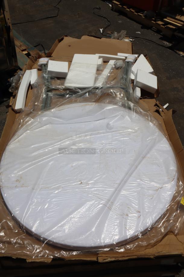 Brand new Lancaster Table & Seating 32" round granite white folding table in original plastic wrap. Packaging slightly damaged.