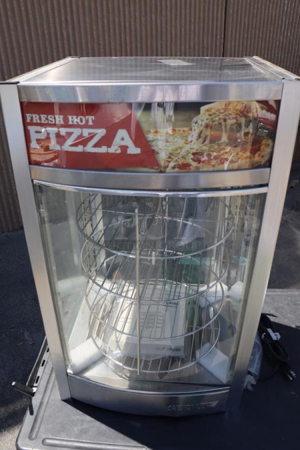 Brand new ServIt PDW12D1 12" pizza warmer, 4-shelf rotating rack, glass intact, minor dent, 18x17x31 inches, 800W, 120V.