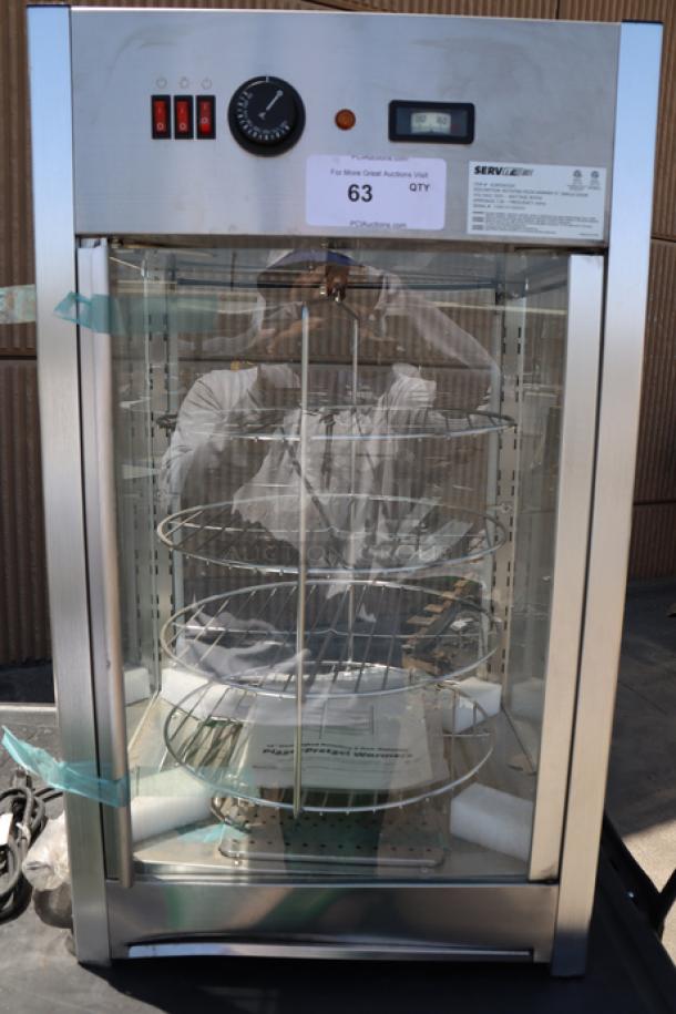 ServIt PDW12D1 12" pizza warmer with 4-shelf rotating rack. All glass intact, minor denting. 120V, 800W, 18x17x31 in.