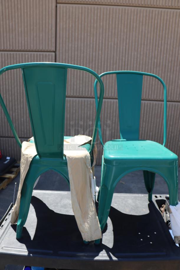 Brand new Lancaster Table & Seating alloy turquoise outdoor café chairs, model 164CMCAFEARC, shown out of packaging.