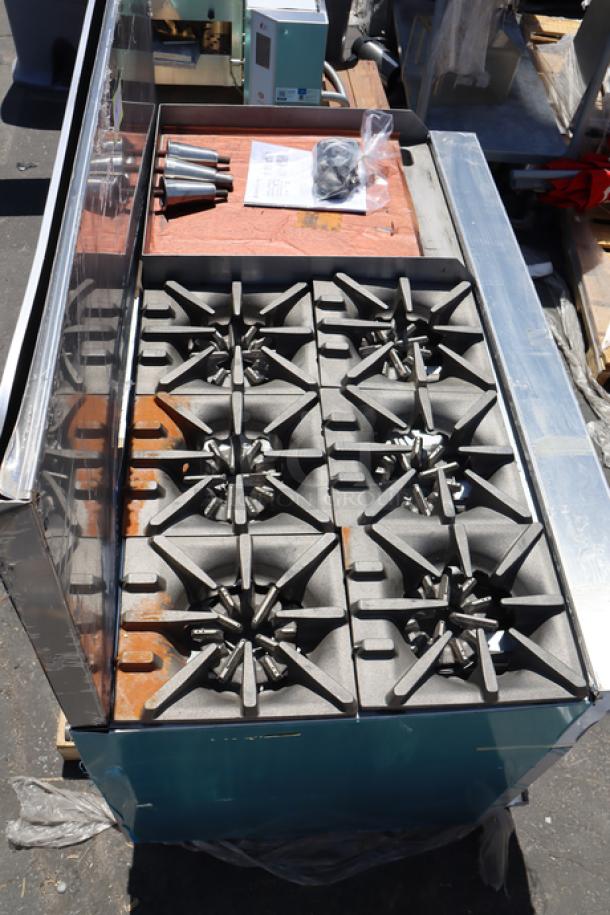 Brand new Garland G60-6G24RR natural gas range, 6 burners, 24" griddle, 2 ovens, 60" wide, 310,000 BTU. Scratch-n-dent condition.
