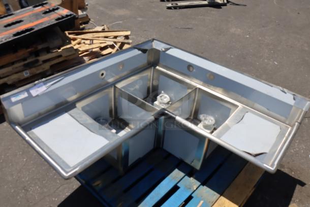 Brand new Regency 600S31620C stainless steel 3-compartment corner sink. Scratch-n-dent condition, with two drainboards.