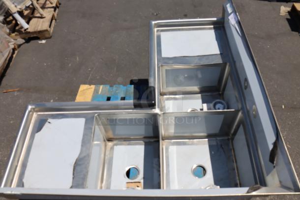 Brand new Regency 600S31620C corner sink, 57" stainless steel, three compartments, two drainboards, 16" x 20" x 14" bowls.