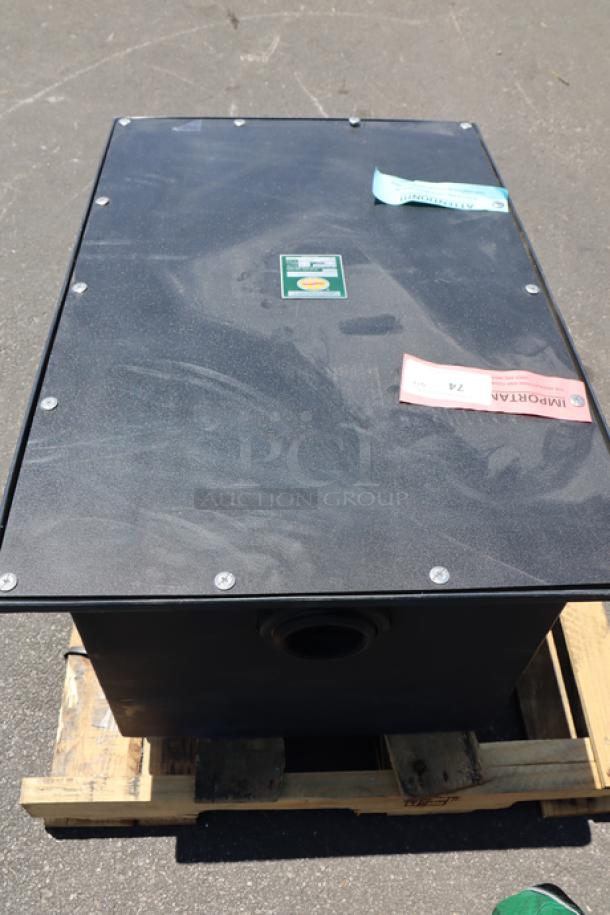 Brand new Ashland PolyTrap 4850 grease trap, 100 lb. capacity, with threaded connections; minor scratches from storage.