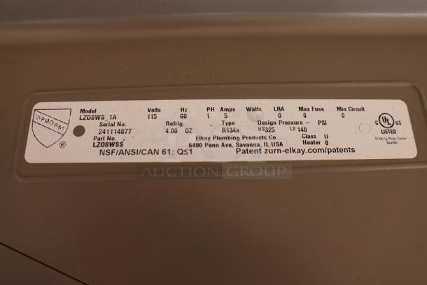 Label on Zurn Elkay LZO8S drinking fountain, model LZ08WS, serial 241114877, with technical specs and compliance info visible.