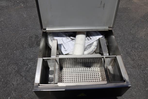 BRAND NEW Fryclone 259OFM55 55 lb. fryer oil filter machine, open showing interior, manuals, slight oil residue, 120V.