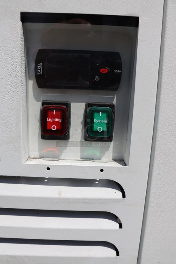 Avantco WVAC-28HC air curtain merchandiser control panel with red lighting and green system switches, pristine condition.