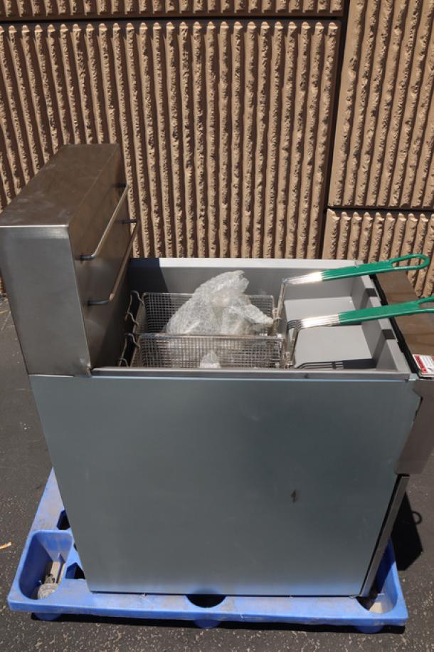 Brand new Avantco EF40-208-3 40 lb. electric floor fryer on a pallet, with protective wrap in baskets, serial number 2406043205.