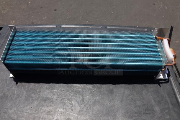 Brand new Avantco 17812873HC evaporator coil, out of original packaging, showing minor scratches.